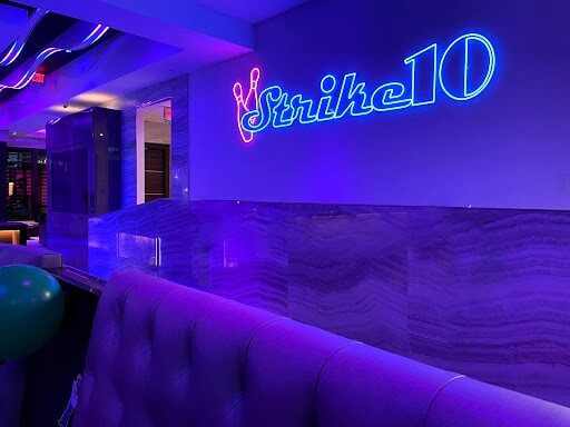 The ambient neon glow creates a striking effect at Strike10 Bowling in Boca Raton, FL